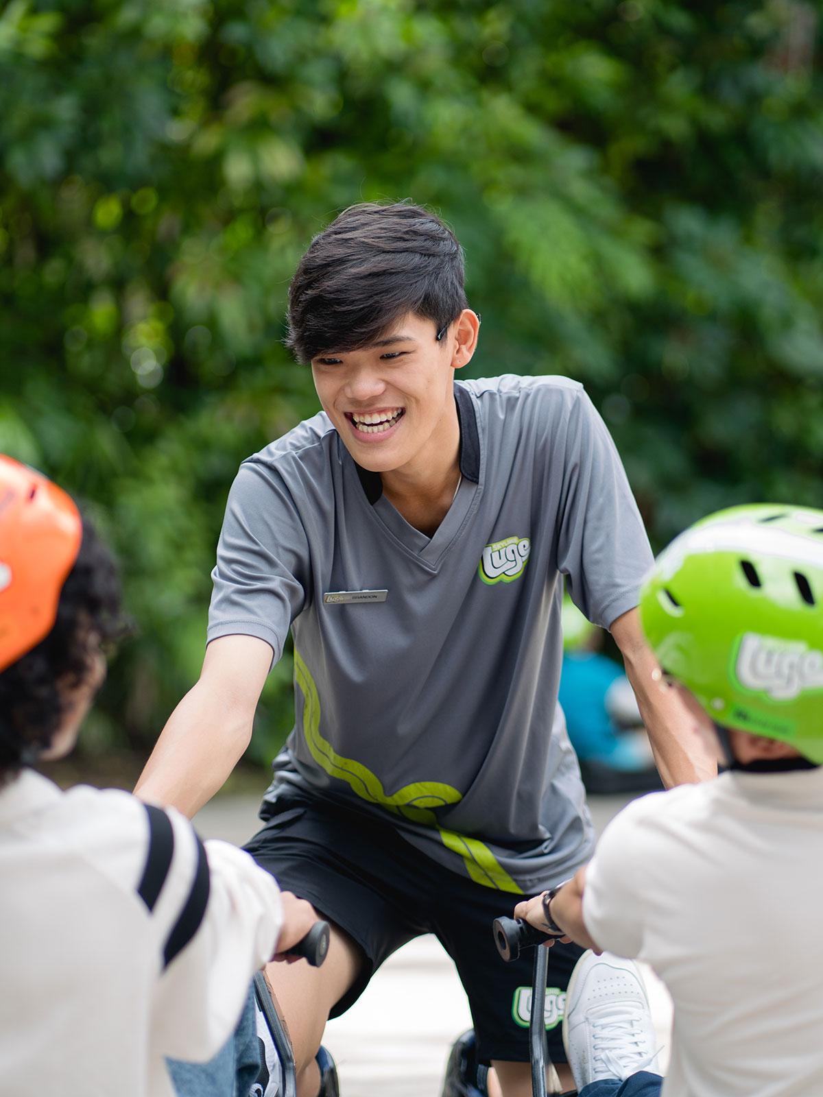 An Operations Host at Skyline Luge Singapore helping riders with their Luge Carts
