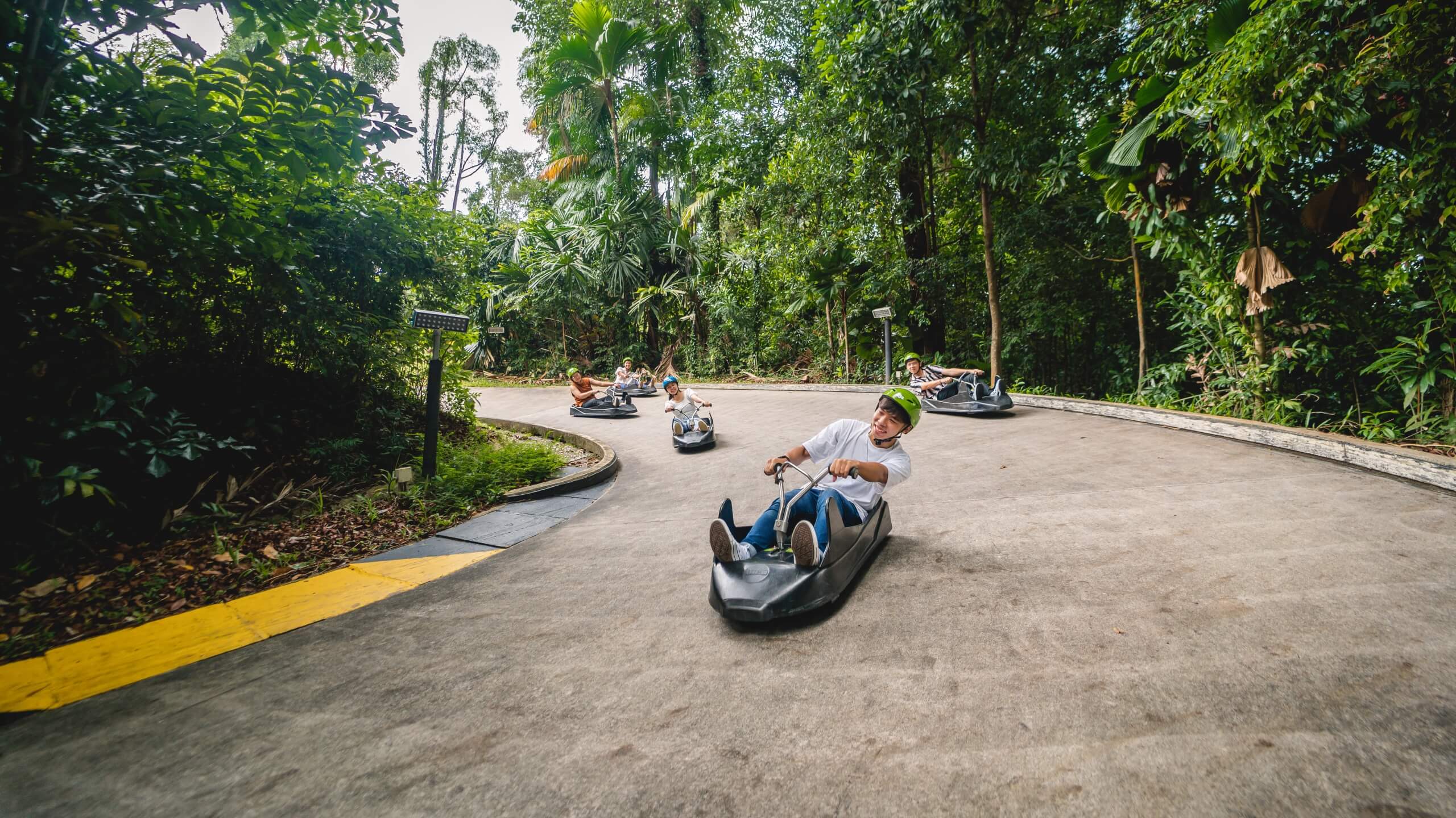 Families riding the Skyline Luge on Sentosa