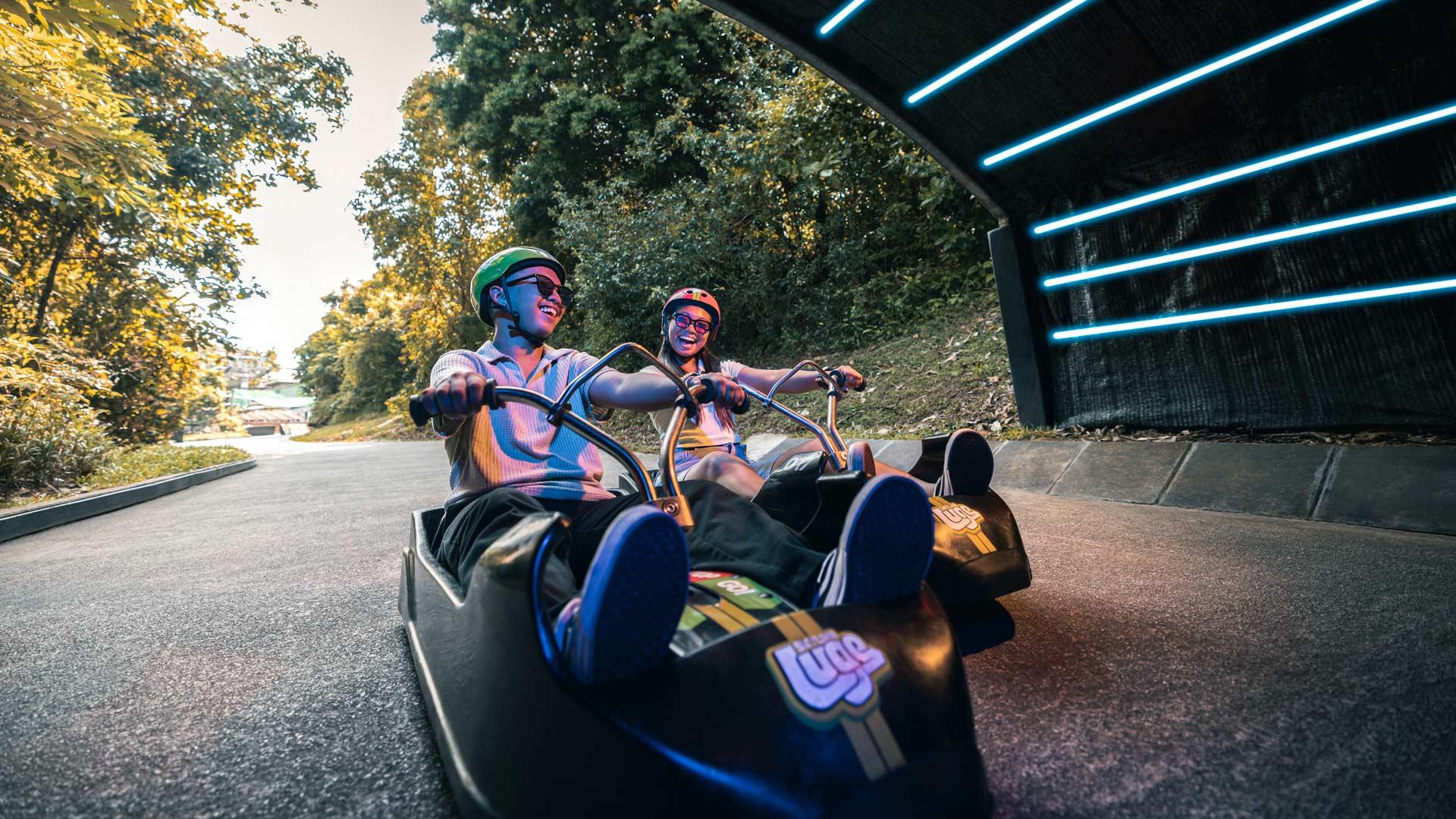 A couple enjoying on the Luge Carts entering the Tunnel feature of the Luge Track