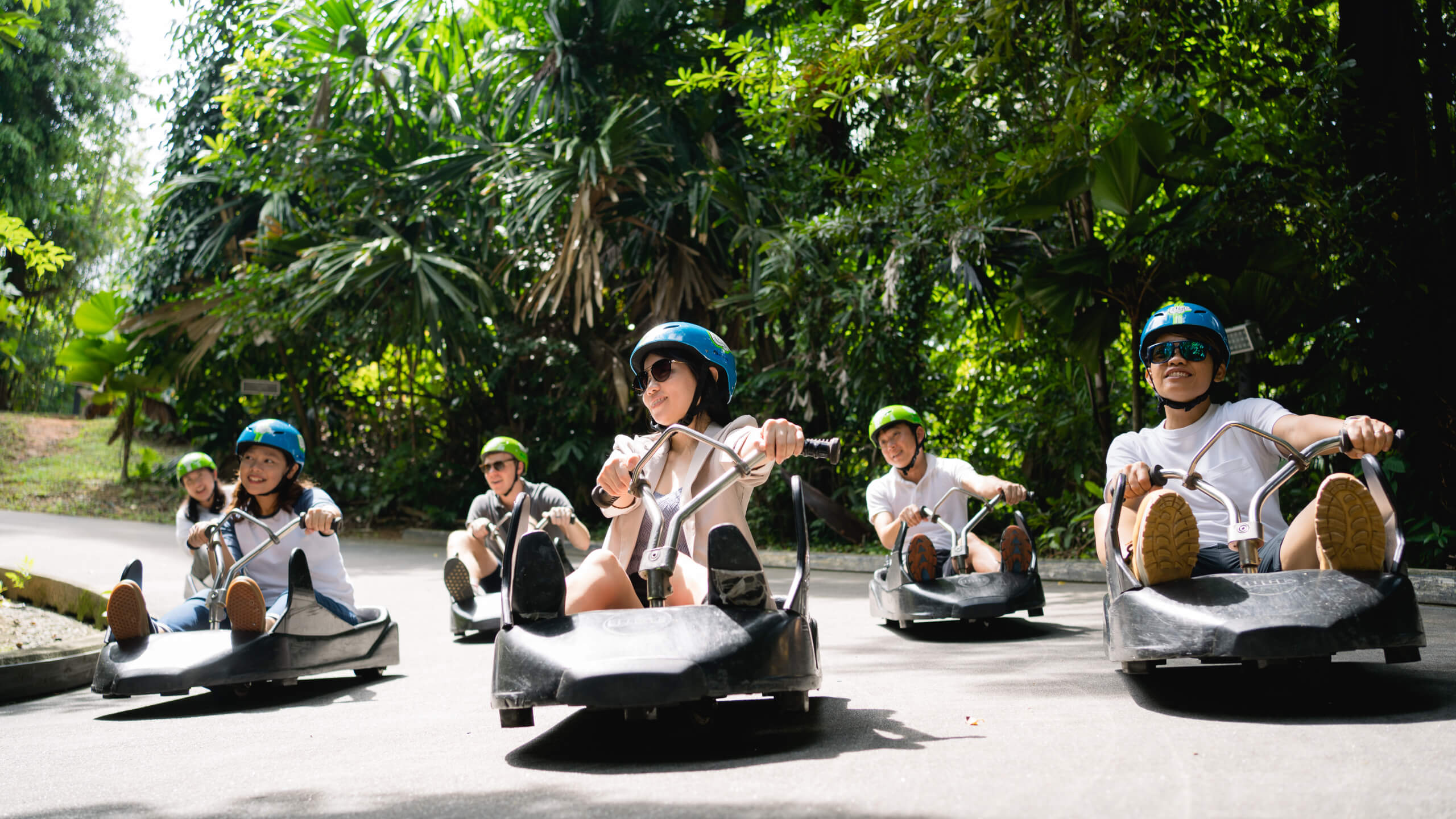 A group of customers ride down the tracks together.