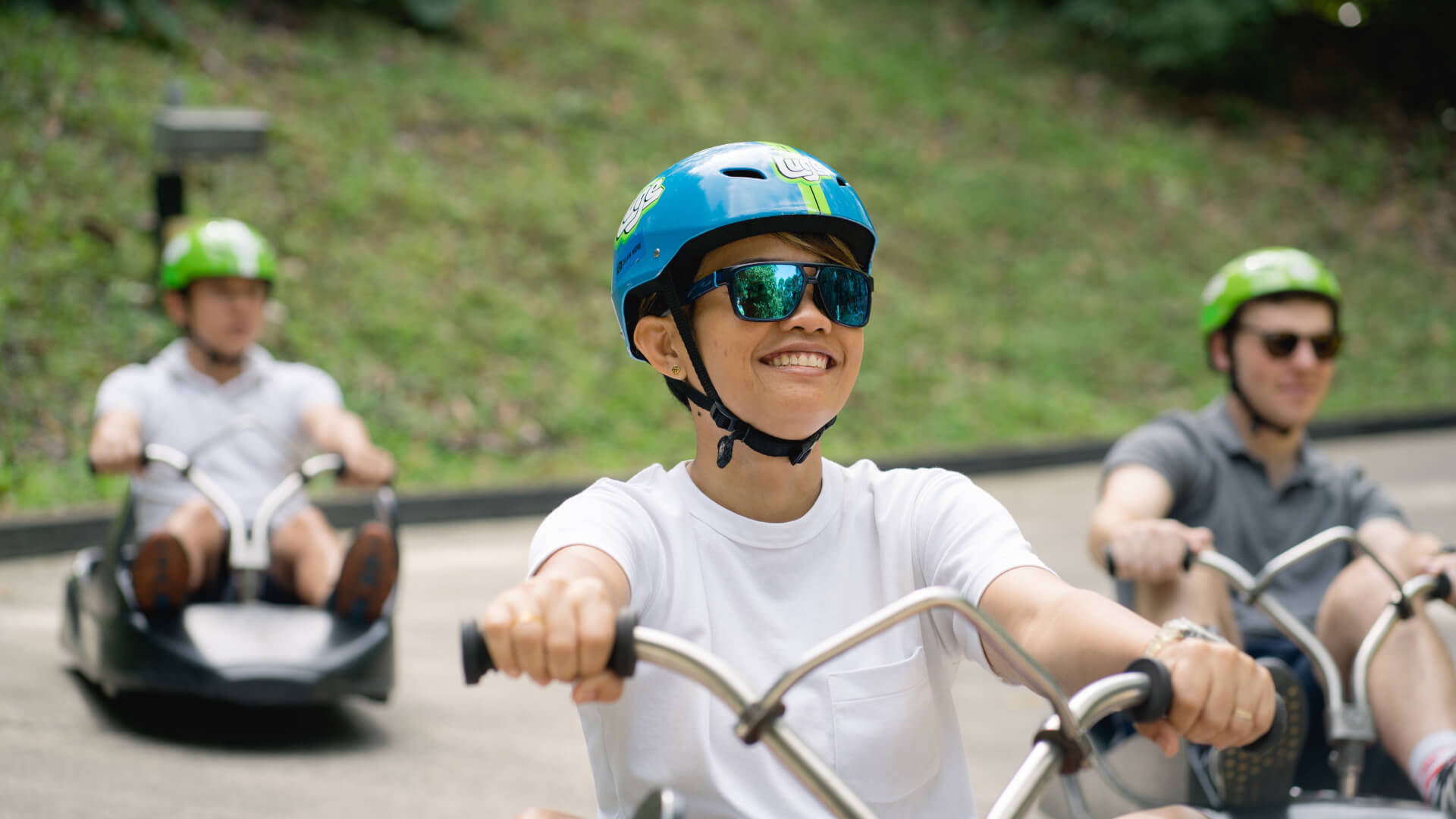 A customer grins as he rides down the Luge tracks.