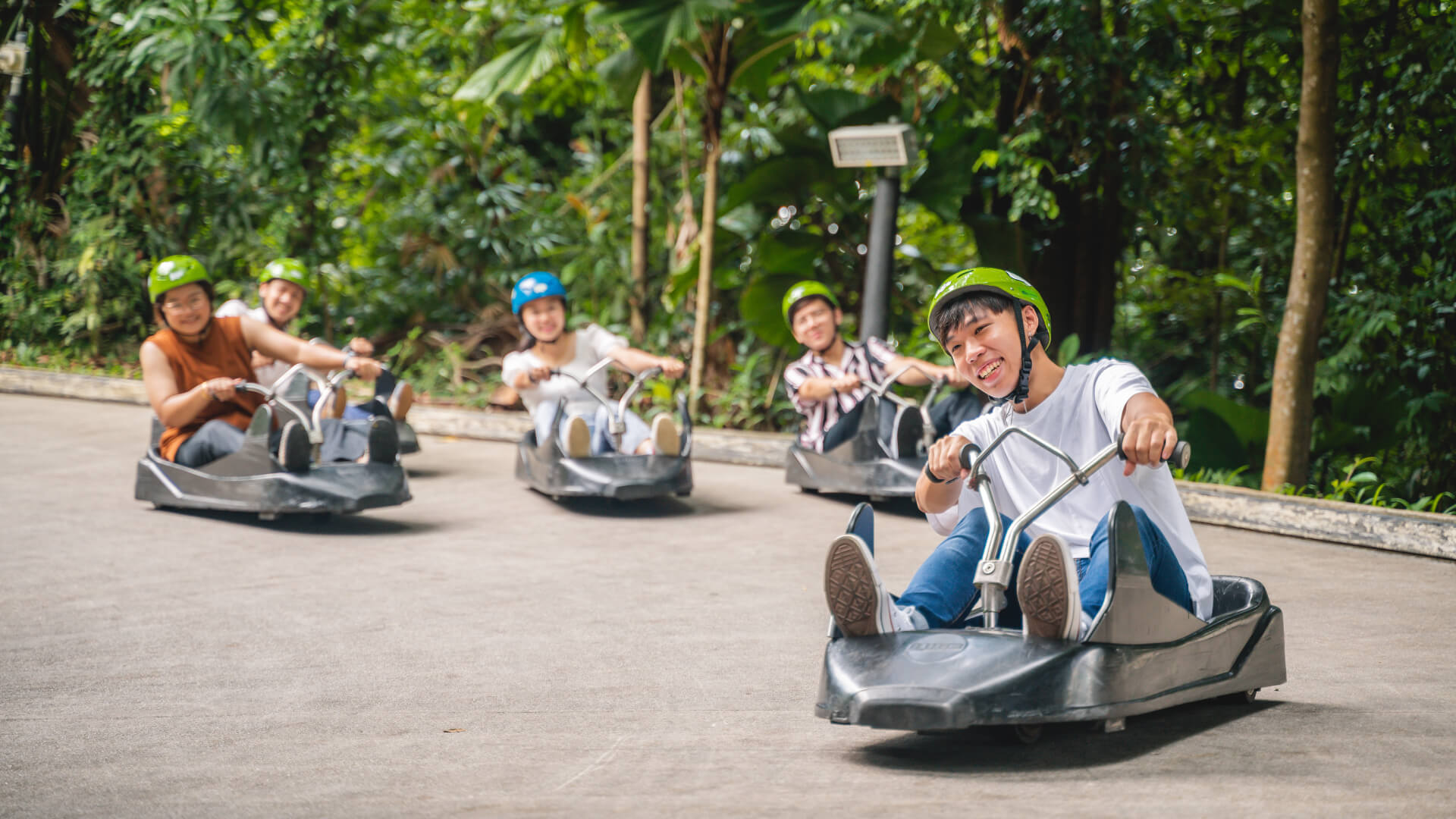 A man leads his friends down the Luge tracks.