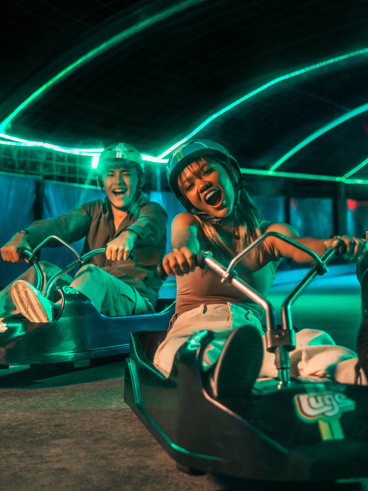 A group of people enjoy the Night Luge together.