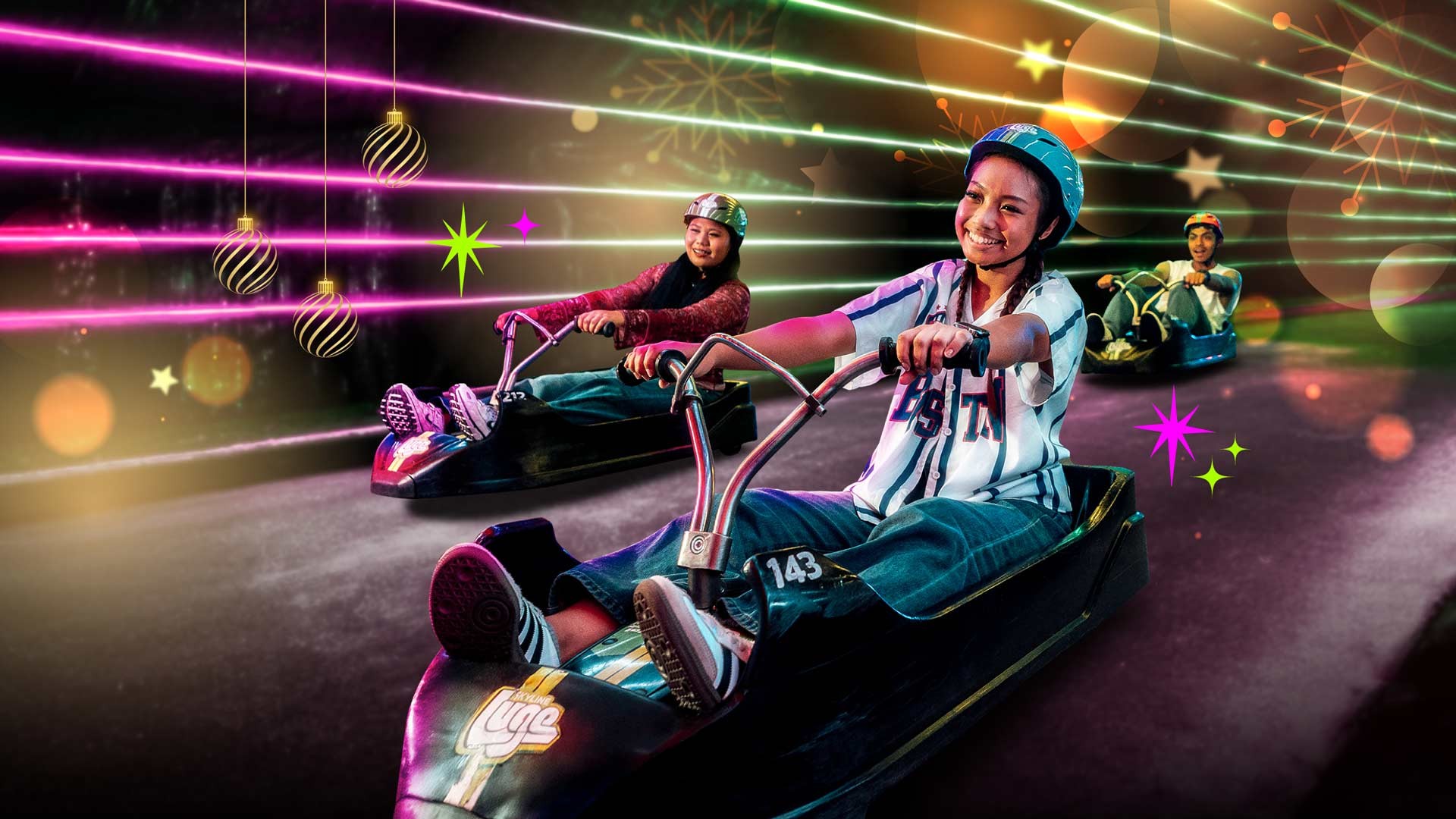 Skyline Luge Singapore A group of friends riding the Luge carts surrounded by Christmas themed graphics