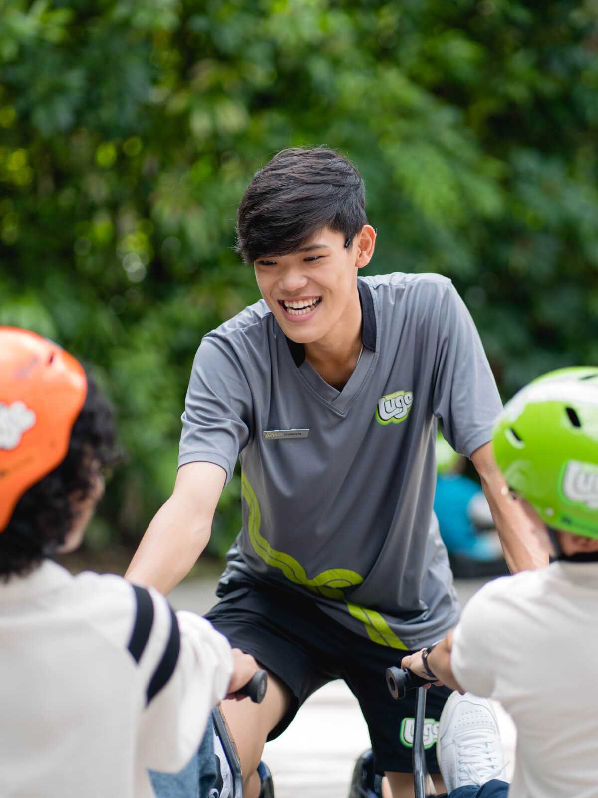 A Luge employee smiles as he teaches customers to use the carts.