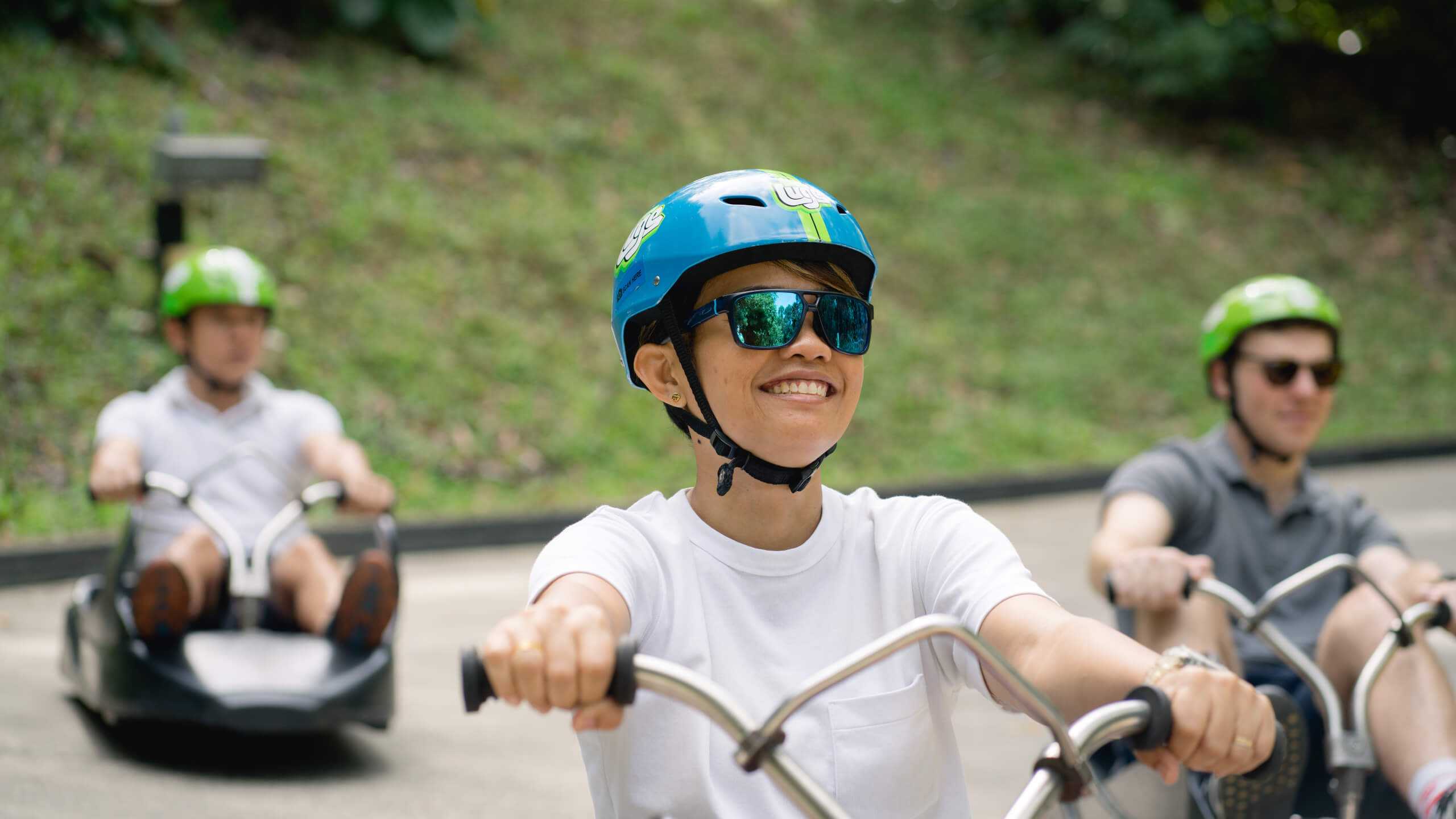 A customer grins as he rides down the Luge tracks.