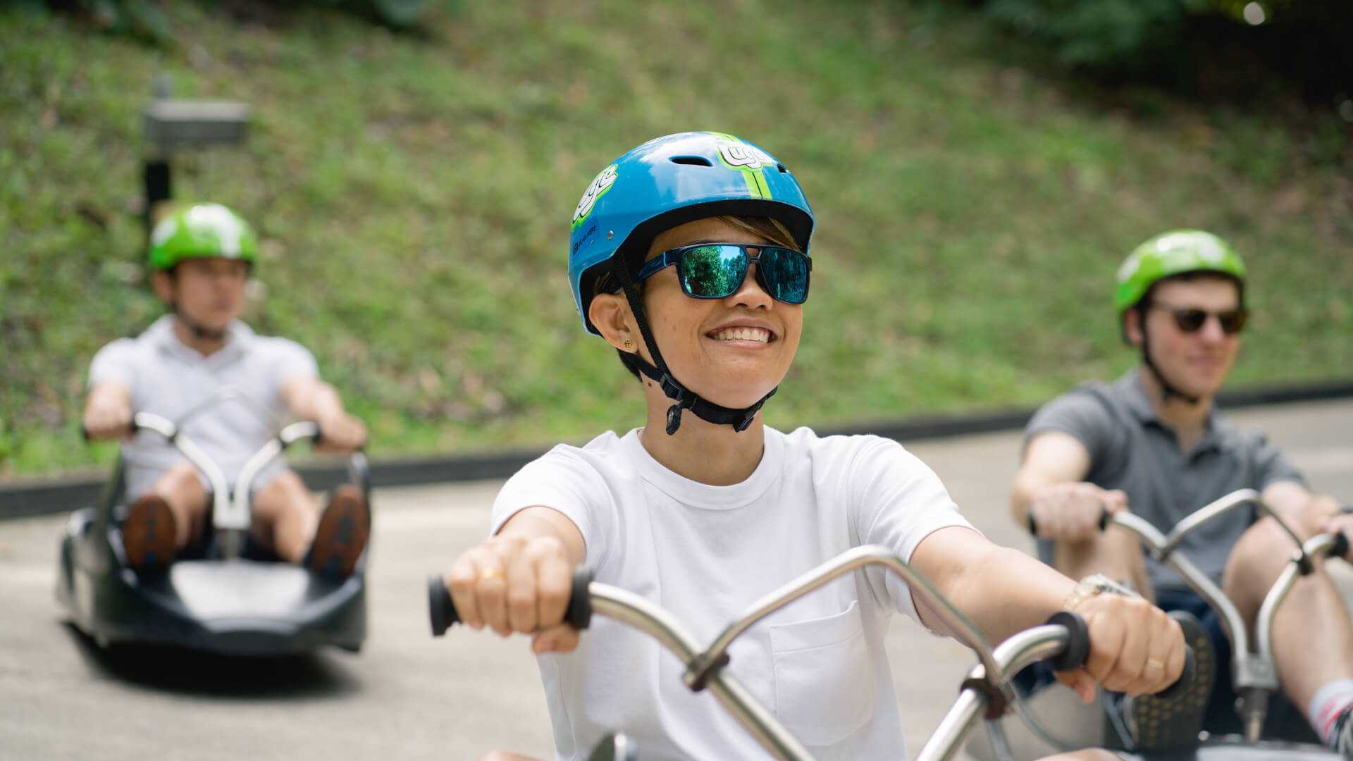 A customer grins as he rides down the Luge tracks.