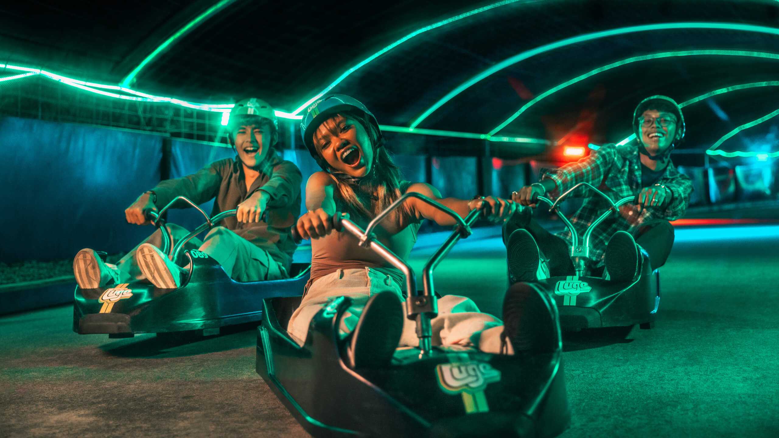 A group of people enjoy the Night Luge together.
