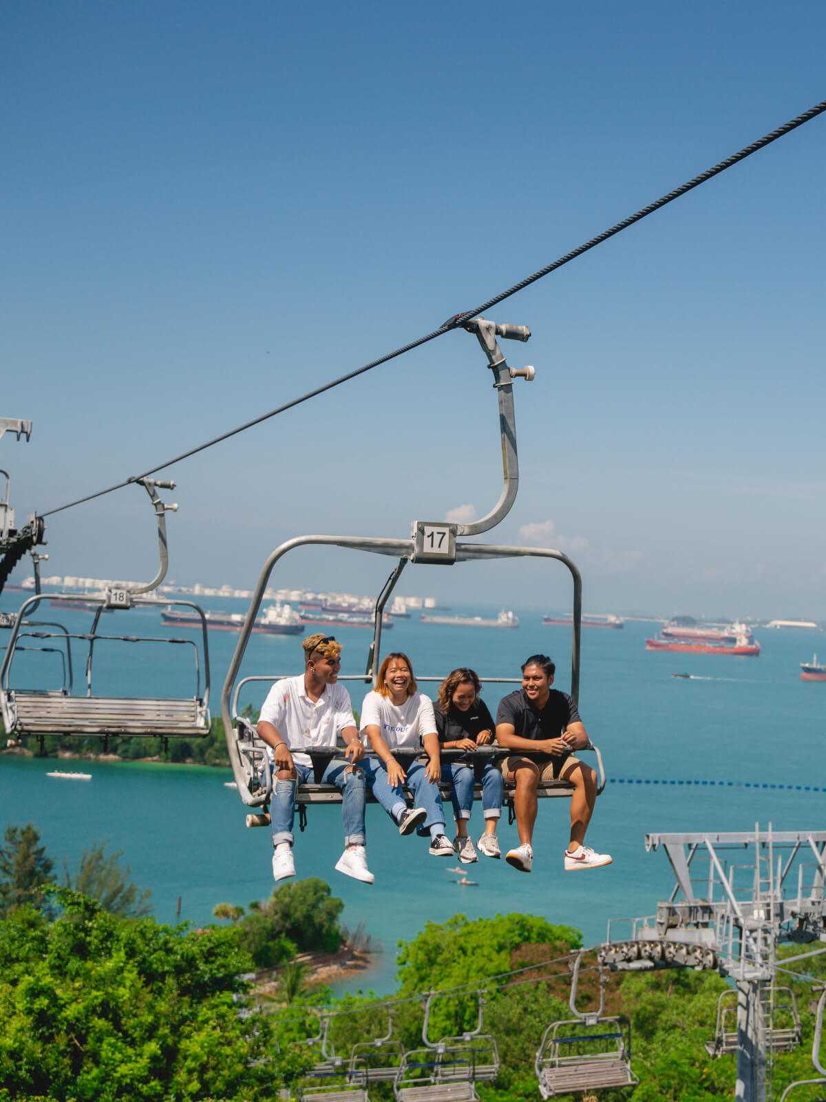 A group of friends laugh as they ride the Skyride chairlift to the top of the Luge tracks.