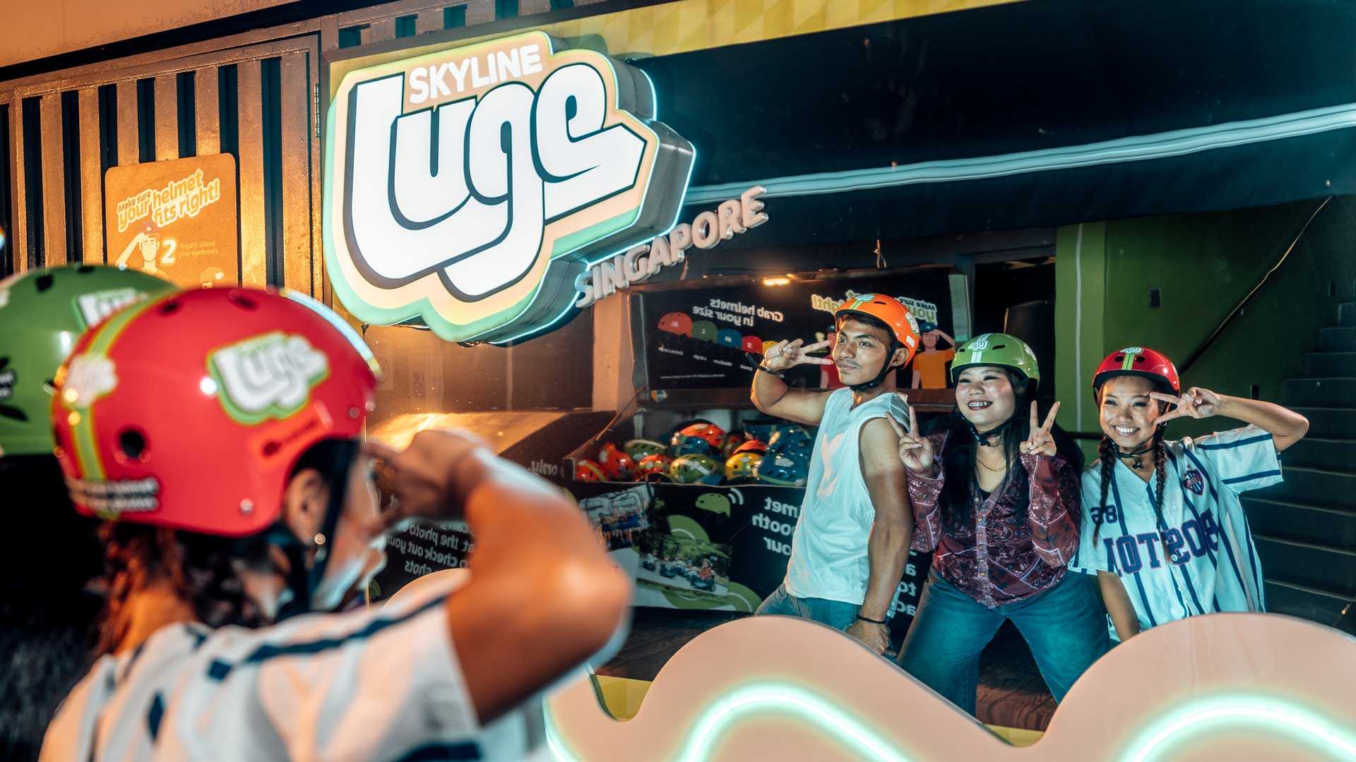 A group of youths in Y2K era fashion posing in front of a mirror at Skyline Luge Singapore