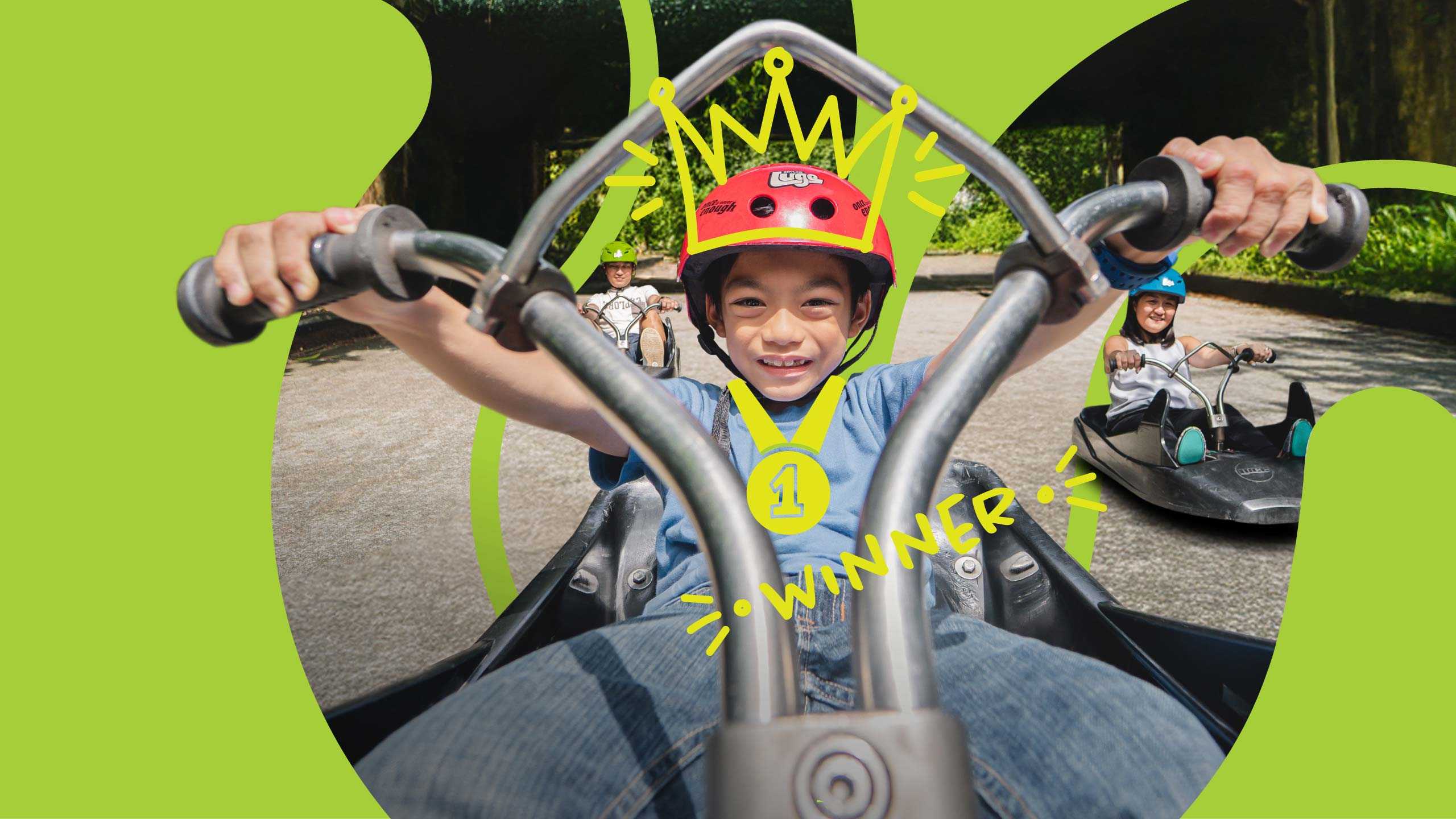100 Million Rides Skyline Luge Singapore - a child on the luge cart smiling with a sketched element of a crown on in his head and the word "winner"