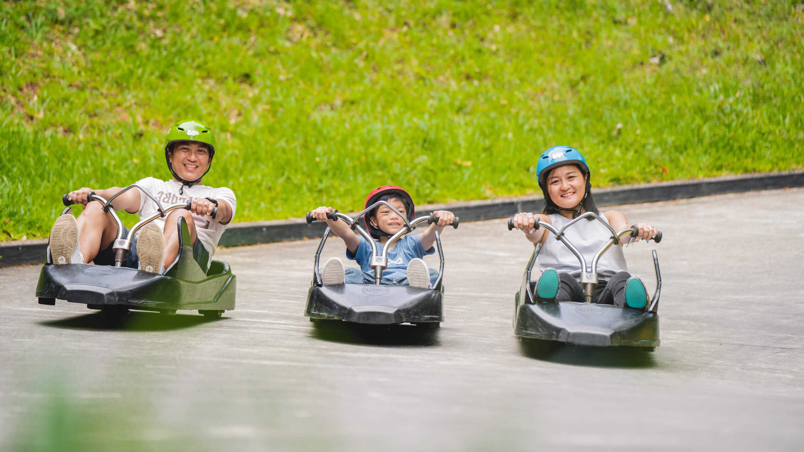 A mother, father and son ride down the tracks together.