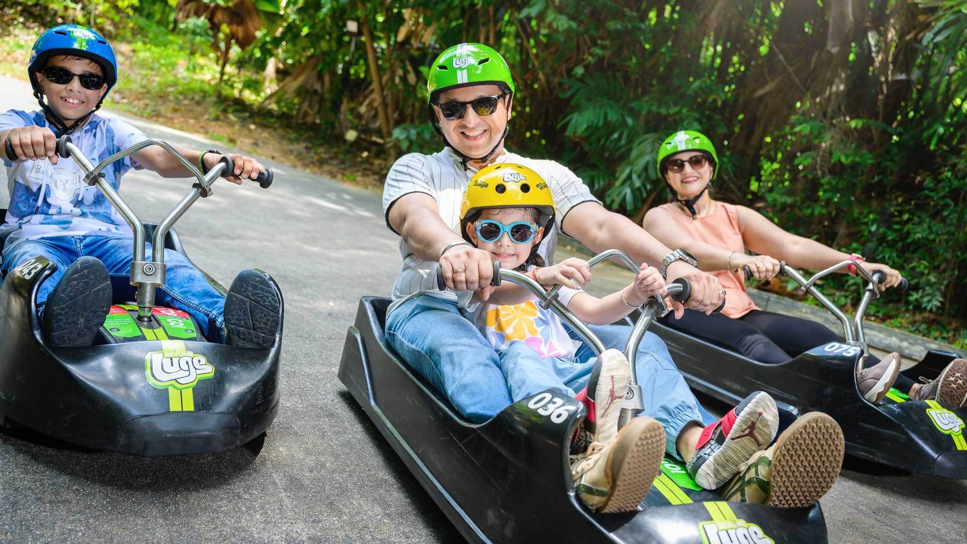 Skyline Luge Singapore A Family on Luge Carts with a Child in Tandem